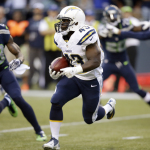 San Diego Chargers running back Branden Oliver carries the ball as Seattle Seahawks cornerback Phillip Adams (28) closes in during the first half of a preseason NFL football game, Friday, Aug. 15, 2014, in Seattle. (AP Photo/Stephen Brashear)