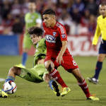 Seattle Sounders FC forward Nelson Valdez, left, goes down after colliding with FC Dallas midfielder Victor Ulloa (8) during the first half of an MLS soccer western conference semifinal playoff match Sunday, Nov. 8, 2015, in Frisco, Texas. Dallas won 4-2 on penalty kicks. (AP Photo/Brad Loper)