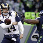 St. Louis Rams quarterback Shaun Hill (14) throws downward under pressure from Seattle Seahawks' Cliff Avril in the second half of an NFL football game, Sunday, Dec. 28, 2014, in Seattle. The Seahawks won 20-6. (AP Photo/Elaine Thompson)