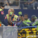 Seattle Seahawks' Ricardo Lockette holds up his hands as medical crew cart him off the field after suffering an unknown injury in the first half of an NFL football game against the Dallas Cowboys, Sunday, Nov. 1, 2015, in Arlington, Texas. (AP Photo/Brandon Wade)