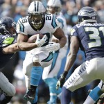 Carolina Panthers running back Jonathan Stewart (28) runs against Seattle Seahawks strong safety Kam Chancellor (31) during the first half of an NFL divisional playoff football game, Sunday, Jan. 17, 2016, in Charlotte, N.C. (AP Photo/Bob Leverone)