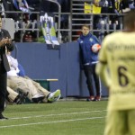 Club America coach Ignacio Ambriz, left, calls to his team from the sideline during the second half of a CONCACAF Champions League soccer quarterfinal against the Seattle Sounders, Tuesday, Feb. 23, 2016, in Seattle. The match ended in a 2-2 draw. (AP Photo/Ted S. Warren)
