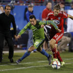 Seattle Sounders FC midfielder Marco Pappa (10) battles with FC Dallas midfielder Ryan Hollingshead (12) during the overtime period of an MLS soccer western conference semifinal playoff match Sunday, Nov. 8, 2015, in Frisco, Texas. Dallas won 4-2 on penalty kicks. (AP Photo/Brad Loper)
