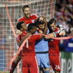 FC Dallas goalkeeper Jesse Gonzalez (44) is mobbed by teammates after winning 4-2 against the Seattle Sounders FC  during the shootout period of an MLS soccer western conference semifinal playoff match Sunday, Nov. 8, 2015, in Frisco, Texas. FC Dallas players left to right are Kellyn Acosta, Ryan Hollingshead, Fabian Castillo, goalkeeper Jesse Gonzalez and Matt Hedges. (AP Photo/Brad Loper)