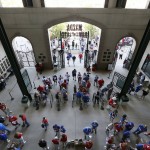 Fans enter the home plate gate for the Opening Day baseball game between the Seattle Mariners and Texas Rangers, Monday, April 4, 2016, in Arlington, Texas. (AP Photo/Brandon Wade)