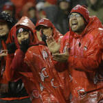 Utah fans cheer in the ran during the first half of an NCAA college football game against Washington, Saturday, Nov. 7, 2015, in Seattle. (AP Photo/Ted S. Warren)