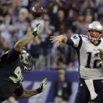 New England Patriots quarterback Tom Brady (12) throws a pass as Seattle Seahawks defensive tackle Kevin Williams (94) pressures during the first half of NFL Super Bowl XLIX football game Sunday, Feb. 1, 2015, in Glendale, Ariz. (AP Photo/Matt Slocum)
