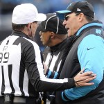 Carolina Panthers head coach Ron Rivera speaks to referee Tony Corrente (99) during the second half of an NFL divisional playoff football game against the Seattle Seahawks, Sunday, Jan. 17, 2016, in Charlotte, N.C. (AP Photo/Mike McCarn)