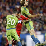 Seattle Sounders FC defender Chad Marshall, right, clears a ball in front of FC Dallas forward Blas Perez, middle, during the second half of an MLS soccer western conference semifinal playoff match Sunday, Nov. 8, 2015, in Frisco, Texas. Dallas won 4-2 on penalty kicks. Seattle Sounders FC defender Zach Scott (20) is at left. (AP Photo/Brad Loper)