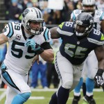 Carolina Panthers middle linebacker Luke Kuechly (59) runs an intercepted ball as Seattle Seahawks center Patrick Lewis (65) looks on during the first half of an NFL divisional playoff football game, Sunday, Jan. 17, 2016, in Charlotte, N.C. Kuechly scored a touchdown on the play. (AP Photo/Chuck Burton)