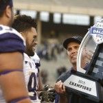 Washington head coach Chris Petersen celebrates with players including Washington defensive lineman Taniela Tupou (90) after Washington's 44-31 victory over Southern Mississippi at the Heart of Dallas Bowl NCAA college football game, Saturday, Dec. 26, 2015, in Dallas. (AP Photo/Ron Jenkins)