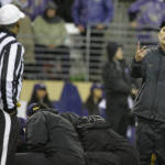 Washington coach Chris Petersen, right, talks with referee Michael Mothershed, left, during an injury timeout in the second half of an NCAA college football game against Utah, Saturday, Nov. 7, 2015, in Seattle. Utah won 34-23. (AP Photo/Ted S. Warren)