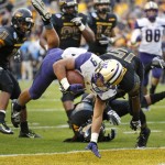 Washington fullback Myles Gaskin (9) scores a touchdown against Southern Mississippi defensive back Devonta Foster (15) during the second half of the Heart of Dallas Bowl NCAA college football game, Saturday, Dec. 26, 2015, in Dallas. (AP Photo/Ron Jenkins)