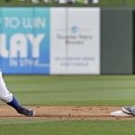 Seattle Mariners' Leonys Martin, left, beats the tag by Texas Rangers second baseman Rougned Odor to steal second during the second inning of a spring training baseball game Sunday, March 6, 2016, in Surprise, Ariz. (AP Photo/Charlie Riedel)