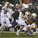 Washington's Dwayne Washington comes down on top of Utah defensive back Justin Thomas (12) as he is tackled by Utah's Chase Hansen (22) during the first half of an NCAA college football game, Saturday, Nov. 7, 2015, in Seattle. (AP Photo/Ted S. Warren)