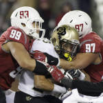 Washington State defensive linemen Darryl Paulo (99) and Destiny Vaeao (97) take down Colorado running back Phillip Lindsay (23) during the first half of an NCAA college football game, Saturday, Nov. 21, 2015, in Pullman, Wash. (AP Photo/Young Kwak)