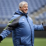 Seattle Sounders head coach Sigi Schmid motions to players during a soccer training session Monday, Feb. 22, 2016, in Seattle. The Sounders play Club America in the CONCACAF Champions League quarterfinal round on Tuesday. (AP Photo/Elaine Thompson)