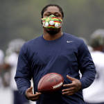Seattle Seahawks' Marshawn Lynch wears a mask as he works out at an NFL football training camp Monday, Aug. 3, 2015, in Renton, Wash. (AP Photo/Elaine Thompson)