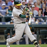Oakland Athletics' Billy Butler singles in a run against the Seattle Mariners during the fifth inning of a baseball game Saturday, May 9, 2015, in Seattle. (AP Photo/Elaine Thompson)