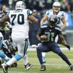 Seattle Seahawks strong safety Kam Chancellor (31) runs toward Carolina Panthers guard Trai Turner (70) after Chancellor intercepted a pass in the second half of an NFL football game, Sunday, Oct. 18, 2015, in Seattle. (AP Photo/Stephen Brashear)