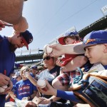 Texas Rangers Josh Hamilton, left, autographs baseballs for fans before a opening day baseball game against the Seattle Mariners, Monday, April 4, 2016, in Arlington, Texas. (AP Photo/Brandon Wade)