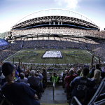 A giant Super Bowl championship banner is unfurled on the field before an NFL football game between the Seattle Seahawks and Green Bay Packers, Thursday, Sept. 4, 2014, in Seattle. (AP Photo/Scott Eklund)