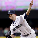 Seattle Mariners starting pitcher J.A. Happ throws against the Oakland Athletics during the first inning of a baseball game Saturday, May 9, 2015, in Seattle. (AP Photo/Elaine Thompson)