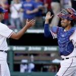 Texas Rangers relief pitcher Shawn Tolleson (37) and catcher Robinson Chirinos, right, celebrate a 3-2 win over the Seattle Mariners after a baseball game, Monday, April 4, 2016, in Arlington, Texas. Texas won 3-2. (AP Photo/Brandon Wade)