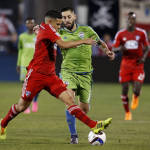 FC Dallas midfielder Victor Ulloa, left, takes the ball away from Seattle Sounders FC forward Clint Dempsey during the first half of an MLS soccer western conference semifinal playoff match, Sunday, Nov. 8, 2015, in Frisco, Texas. Dallas won 4-2 on penalty kicks. (AP Photo/Brad Loper)