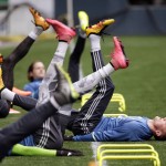 Seattle Sounders defender Dylan Remick, right, stretches with teammates during a soccer training session Monday, Feb. 22, 2016, in Seattle. The Sounders play Club America in the CONCACAF Champions League quarterfinal round on Tuesday. (AP Photo/Elaine Thompson)