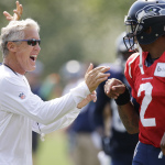 Seattle Seahawks head coach Pete Carroll, left, laughs with backup quarterback Terrelle Pryor, right, during practice drills, Saturday, Aug. 2, 2014, at NFL football training camp in Renton, Wash. (AP Photo/Ted S. Warren)
