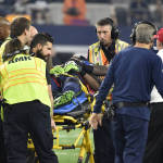 Medical staff prepare to cart Ricardo Lockette off the field as head coach Pete Carroll, front right, watches in the first half of an NFL football game against the Dallas Cowboys, Sunday, Nov. 1, 2015, in Arlington, Texas. (AP Photo/Michael Ainsworth)