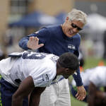 Seattle Seahawks head coach Pete Carroll, right, greets newly acquired player Mohammed Seisay at an NFL football training camp Monday, Aug. 3, 2015, in Renton, Wash. (AP Photo/Elaine Thompson)