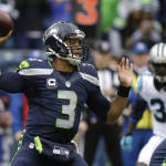 Seattle Seahawks quarterback Russell Wilson passes against the Carolina Panthers in the first half of an NFL football game, Sunday, Oct. 18, 2015, in Seattle. (AP Photo/Elaine Thompson)