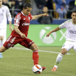 Club Tijuana's Dayro Moreno kicks the ball as Seattle Sounders's Cristian Roldan, right, watches during the second half of an international friendly soccer match, Tuesday, March 24, 2015, in Seattle. The match ended in a 2-2 tie. (AP Photo/Ted S. Warren)