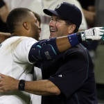 Seattle Mariners' Robinson Cano, left, hugs hitting coach Edgar Martinez, right, after Cano after a win in 2015. (AP)