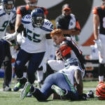 Cincinnati Bengals quarterback Andy Dalton (14) rises to his feet after losing his helmet on a sack by Seattle Seahawks outside linebacker Bruce Irvin (51) in the first half of an NFL football game, Sunday, Oct. 11, 2015, in Cincinnati. (AP Photo/Gary Landers)