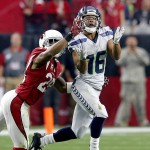 Seattle Seahawks wide receiver Tyler Lockett (16) pulls in a pass as Arizona Cardinals cornerback Justin Bethel (28) defends during the first half of an NFL football game, Sunday, Jan. 3, 2016, in Glendale, Ariz. (AP Photo/Rick Scuteri)