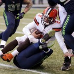 Cleveland Browns quarterback Johnny Manziel (2) is sacked by Seattle Seahawks' Marcus Burley in the second half of an NFL football game, Sunday, Dec. 20, 2015, in Seattle. (AP Photo/Scott Eklund)