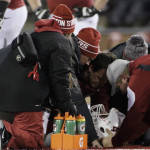 Washington State personnel tend to quarterback Luke Falk (4) after he was tackled and injured during the second half of an NCAA college football game against Colorado, Saturday, Nov. 21, 2015, in Pullman, Wash. Washington State won 27-3. (AP Photo/Young Kwak)