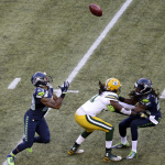 Seattle Seahawks' Earl Thomas, left, prepares to catch a punt during the first half of an NFL football game against the Green Bay Packers, Thursday, Sept. 4, 2014, in Seattle. (AP Photo/Scott Eklund)