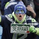 A Seattle Seahawks fan cheers before the first half of an NFL divisional playoff football game between the Carolina Panthers and the Seattle Seahawks, Sunday, Jan. 17, 2016, in Charlotte, N.C. (AP Photo/Bob Leverone)