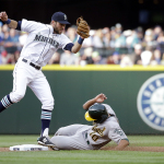Oakland Athletics' Marcus Semien (10) slides safely into second base with a steal as Seattle Mariners shortstop Chris Taylor comes down with the ball during the first inning of a baseball game Saturday, May 9, 2015, in Seattle. (AP Photo/Elaine Thompson)