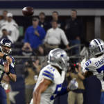 Seattle Seahawks' Russell Wilson (3) passes the ball past Dallas Cowboys' Greg Hardy (76) in the second half of an NFL football game Sunday, Nov. 1, 2015, in Arlington, Texas. (AP Photo/Michael Ainsworth)