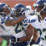 Seattle Seahawks free safety Earl Thomas (29) hugs middle linebacker Bobby Wagner, center, after Wagner's touchdown on a fumble-return in the second half of an NFL football game against the Cincinnati Bengals, Sunday, Oct. 11, 2015, in Cincinnati. (AP Photo/Gary Landers)
