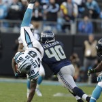 Carolina Panthers outside linebacker Thomas Davis (58) receives an on-side kick from the Seattle Seahawks during the second half of an NFL divisional playoff football game, Sunday, Jan. 17, 2016, in Charlotte, N.C. The Panthers won 31-24. (AP Photo/Bob Leverone)