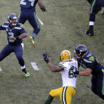 Seattle Seahawks quarterback Russell Wilson (3) looks to pass against the Green Bay Packers during the first half of an NFL football game, Thursday, Sept. 4, 2014, in Seattle. (AP Photo/Scott Eklund)