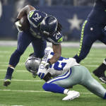 Dallas Cowboys' Morris Claiborne, bottom, tackles Seattle Seahawks' Marshawn Lynch (24) on a running play in the first half of an NFL football game Sunday, Nov. 1, 2015, in Arlington, Texas. (AP Photo/Michael Ainsworth)