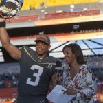 Seattle Seahawks quarterback Russell Wilson (3) of Team Irvin reacts after winning offensive MVP award while being interviewed by ESPN sideline reporter Lisa Salters at the NFL Pro Bowl football game Sunday, Jan. 31, 2016, in Honolulu. Team Irving beat Team Rice 49-27. (AP Photo/Marco Garcia)