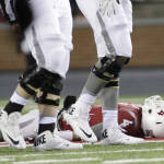 Washington State quarterback Luke Falk (4), who was later carted off the filed, rests after being tackled during the second half of an NCAA college football game against Colorado, Saturday, Nov. 21, 2015, in Pullman, Wash. Washington State won 27-3. (AP Photo/Young Kwak)